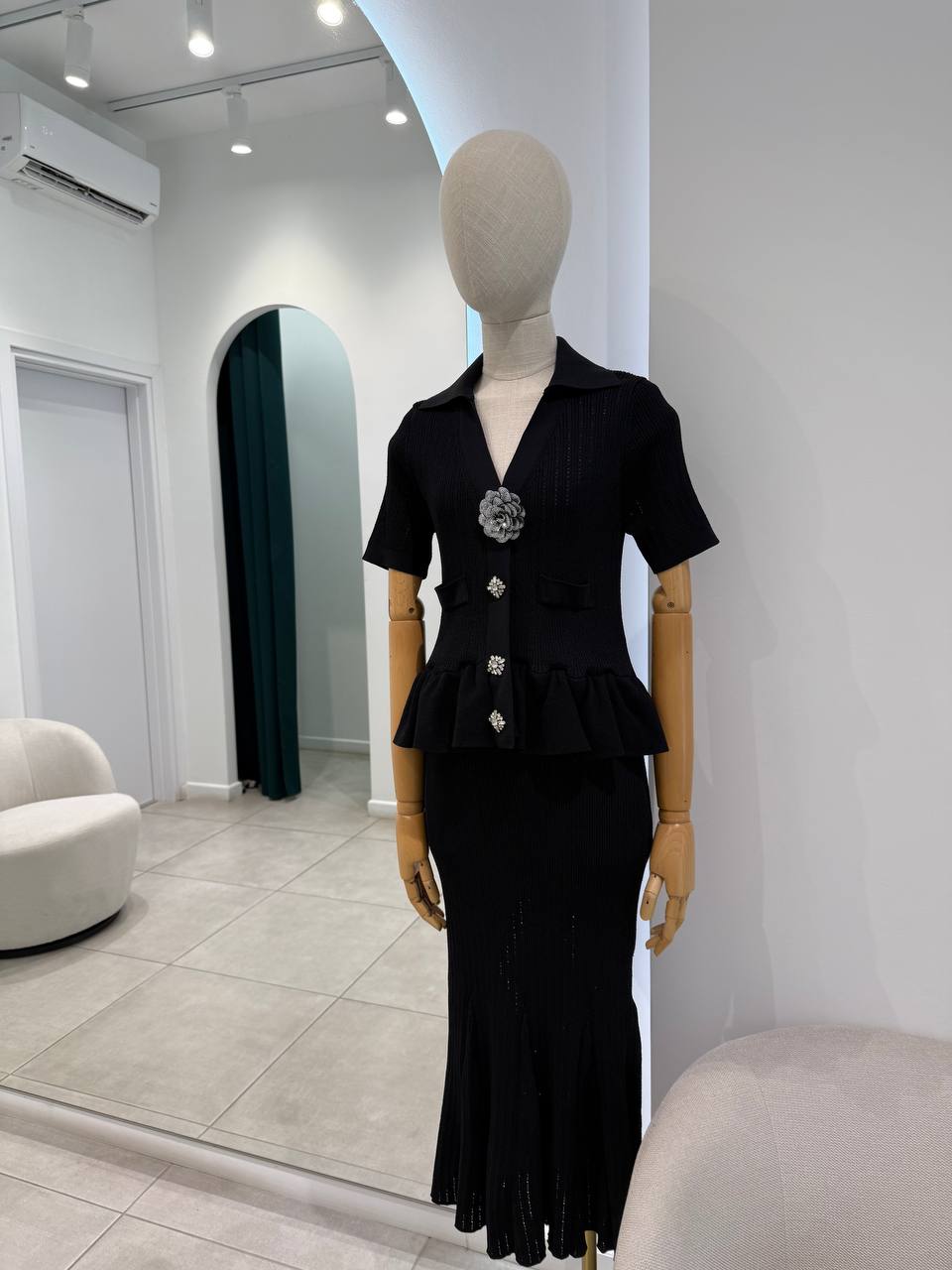 Black knitted dress with embellished broosh