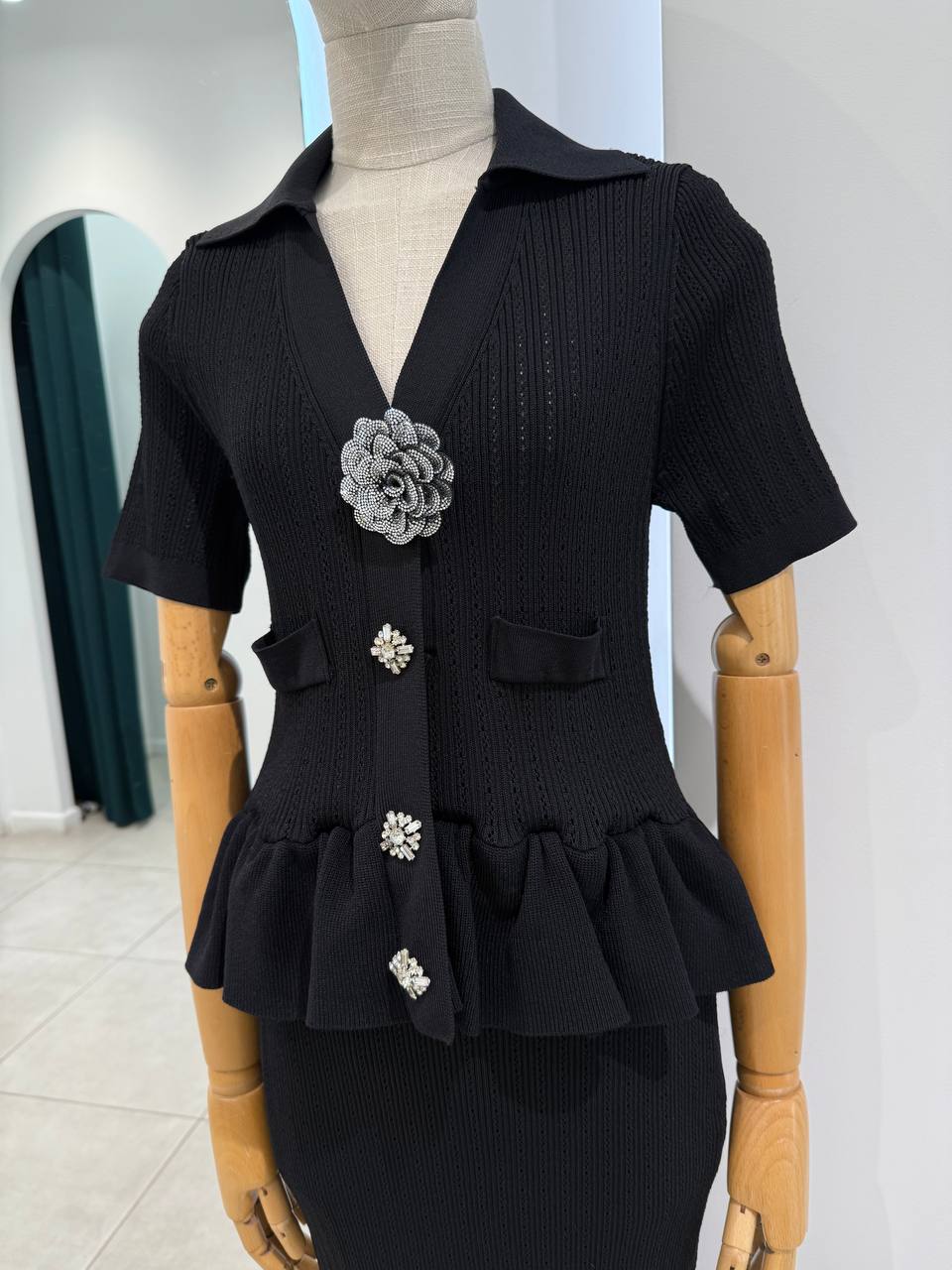 Black knitted dress with embellished broosh